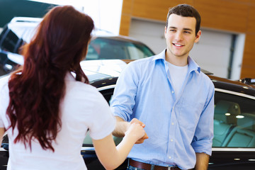 Obraz premium Young happy couple at car salon