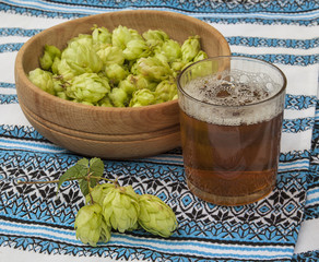 Glass with a drink of hops and  branch of hops