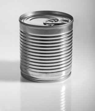 A silver tin can on a grey background.