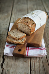 Wholegrain rye bread loaf with flax seeds and oats, sliced