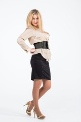 Fototapeta premium Portrait of blond girl in black skirt in the studio