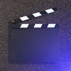 Blank movie production clapper board against dark background