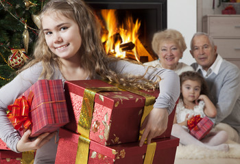 Obraz na płótnie Canvas Happy little girl with Christmas presents