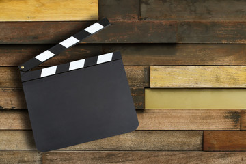 Blank movie production clapper board over vintage wooden wall