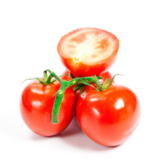 Closeup of tomatoes on the vine isolated on white