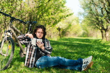 Young man reads book in the garden