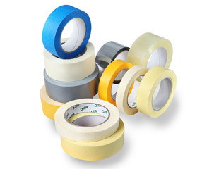 Several rolls of adhesive tapes different colors, sizes.