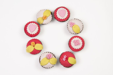 Fototapeta na wymiar Circle of cupcakes isolated on white background