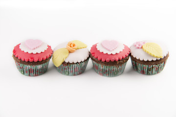 Four red cupcakes isolated on white background