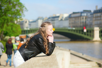 Fototapeta premium Thoughtful Parisian girl at the Seine embankment