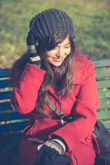 beautiful woman red coat listening music