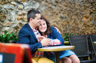 Dating couple in an outdoor Parisian cafe