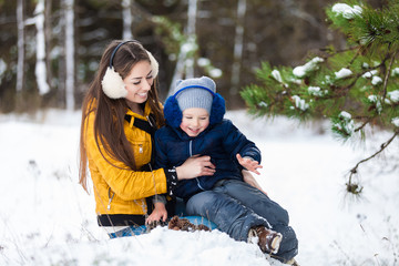 Fototapeta na wymiar Mother and son enjoying beautiful winter day