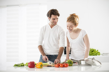couple in the kitchen cooking vegetables