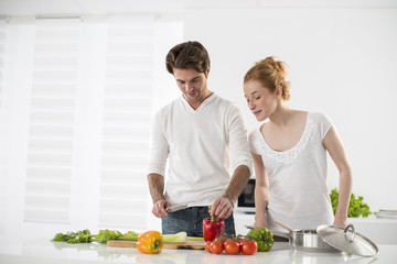 couple in the kitchen cooking vegetables