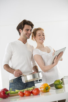 Couple In The Kitchen Cooking Vegetables