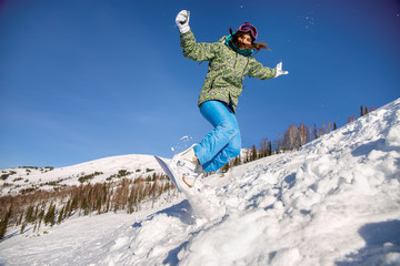 Fototapeta na wymiar Snowboarder jumping