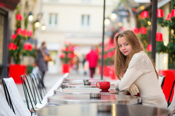 Girl in a Parisian cafe at Christmas time