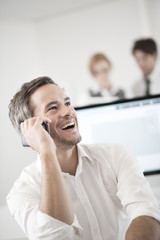 portrait of smiling businessman at phone