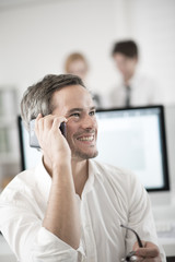 portrait of smiling businessman at phone