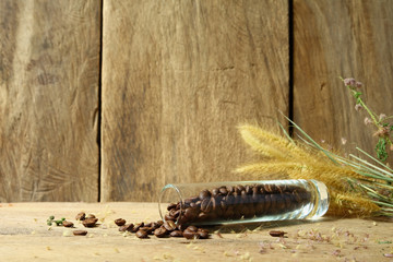Still life roasted coffee beans in glass vase with foxtail weed