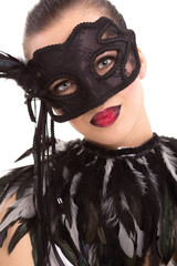 Beautiful young woman in black mysterious venetian mask
