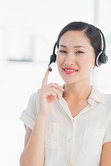 Beautiful smiling female executive with headset