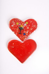 Two red hearts with confetti on the white background