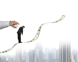 Winding money winder on businessman's back with growing money tr