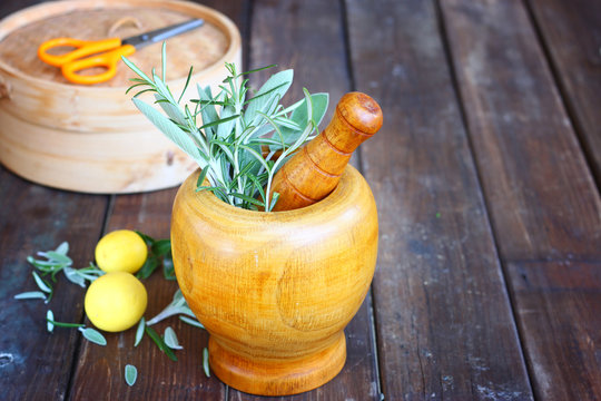 fresh rosemary and sage herbs in wooden pestle and mortar  natur