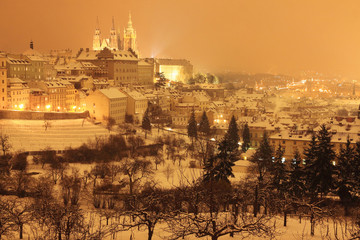 Naklejka premium Night snowy Prague City with gothic Castle, Czech republic
