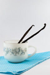 Vanilla pods in a coffee cup.