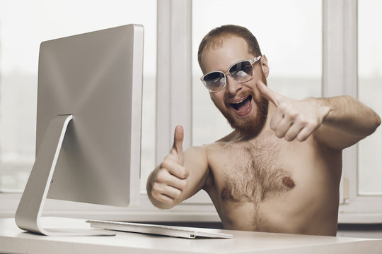 employee in the office dreaming about the rest. Naked in sunglas