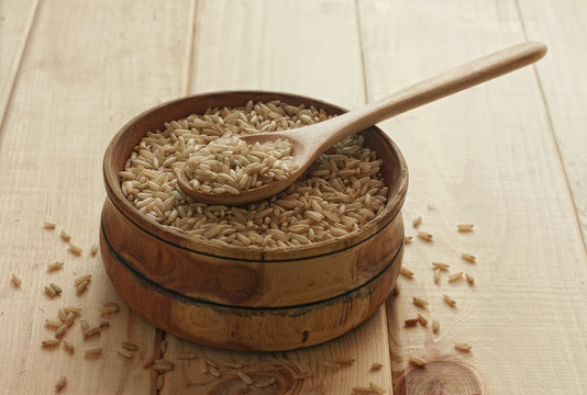 Brown Rice In Wooden Bowl