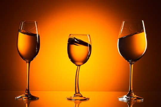 three glasses on orange background