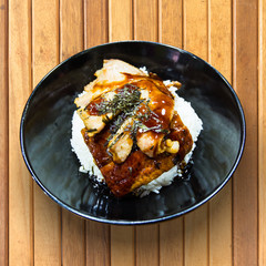 eel on rice unagi in a bowl on wooden table, Japanese cuisine