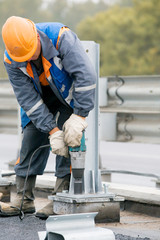 Industrial worker tightening bolts at construction site