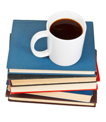 above view of mug of coffee on stack of books