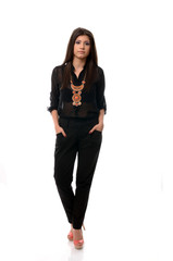 Fashionable young woman posing with hands in pockets