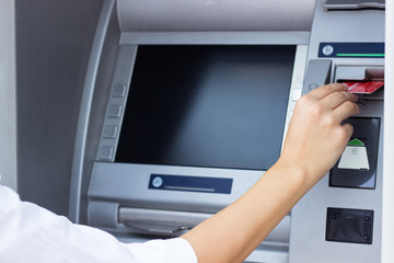 Woman put her credit card at the ATM