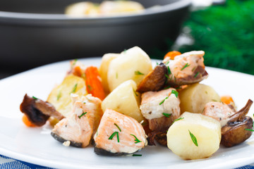 Baked salmon with potato, mushrooms and carrot