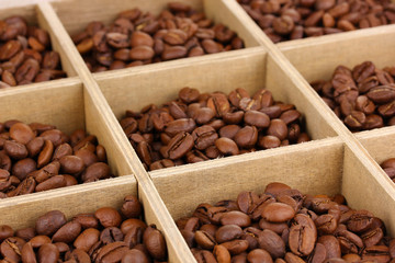 Coffee beans in wooden box close-up