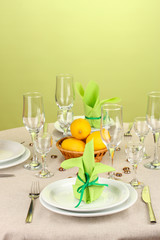 Table setting in green and yellow tones on color  background