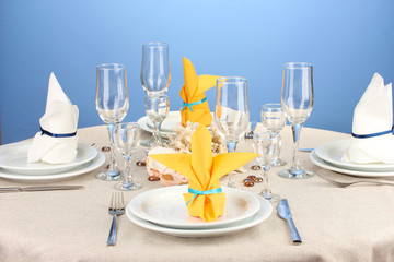 Table setting in white and yellow tones on color  background