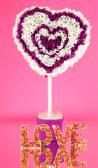 Decorative heart from paper on pink background
