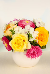 Beautiful bouquet of bright flowers in color vase,