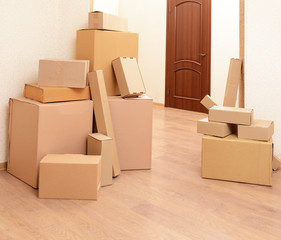 Empty room with stack of cartons: moving house concept