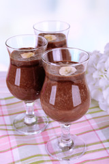 Cocktails with banana and chocolate on table on light