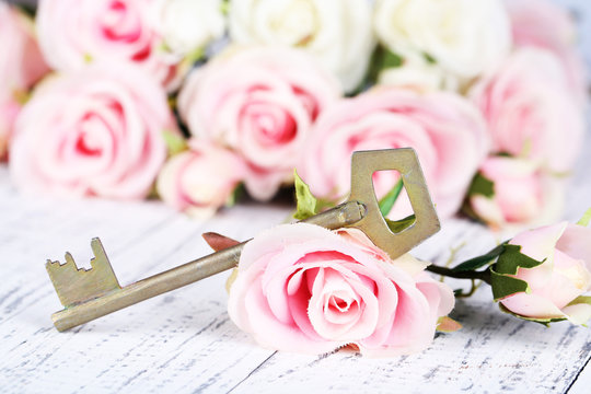 Key of happiness. Conceptual photo. Key with roses,