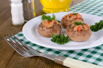 Stuffed mushrooms on plate on table close-up